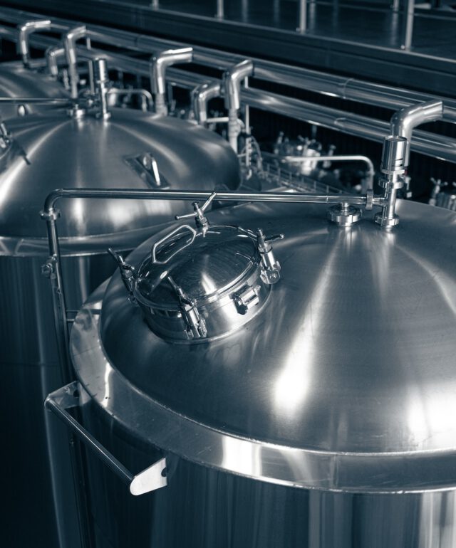 Modern brewery production steel tanks and pipes, machinery tools and vats, beer production